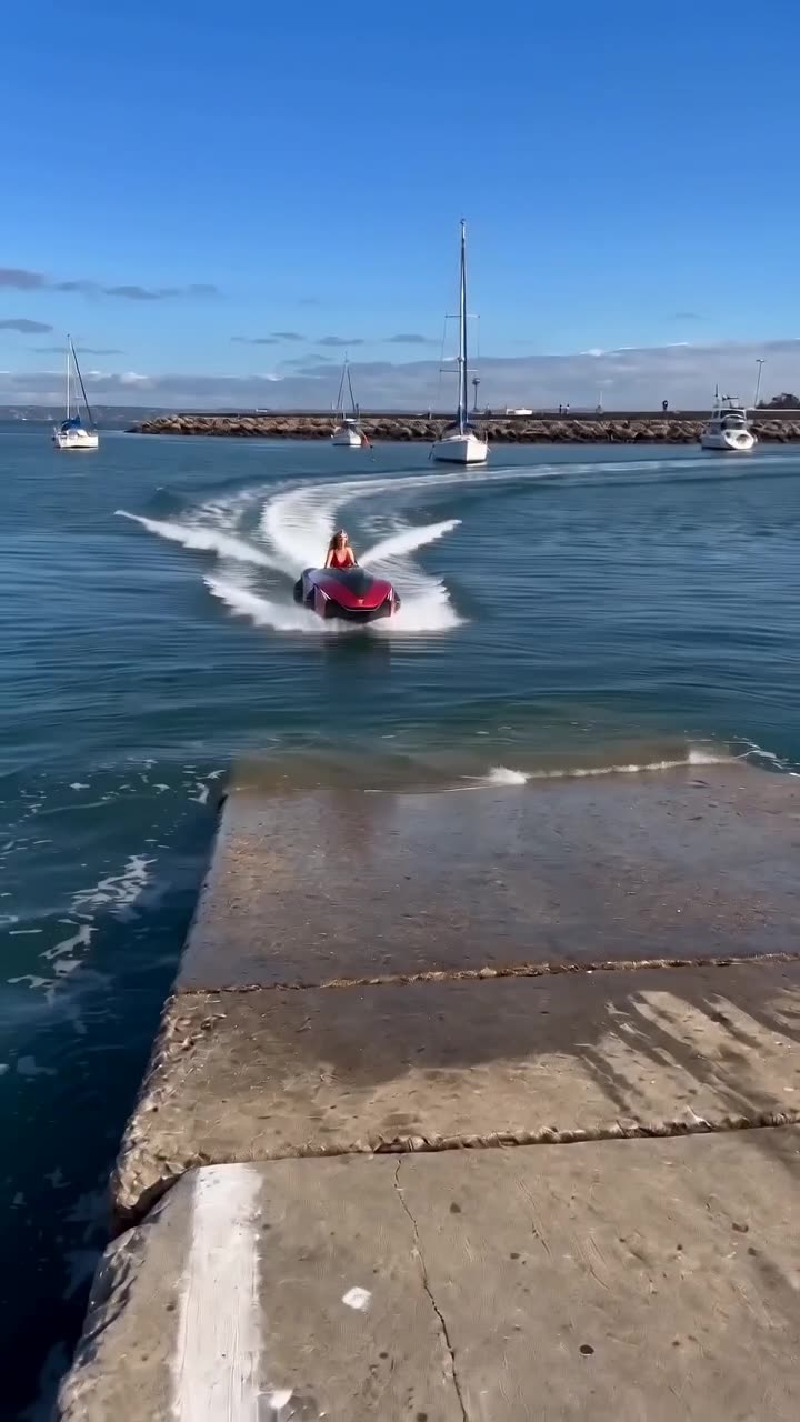 Blonde girl on red jet ski